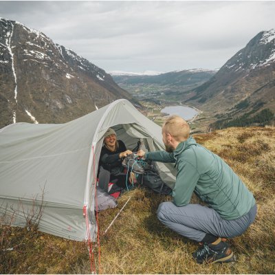 Robens Sprinter 3 LW tält i fjällmiljö – person tar emot utrustning från insidan av tältet.